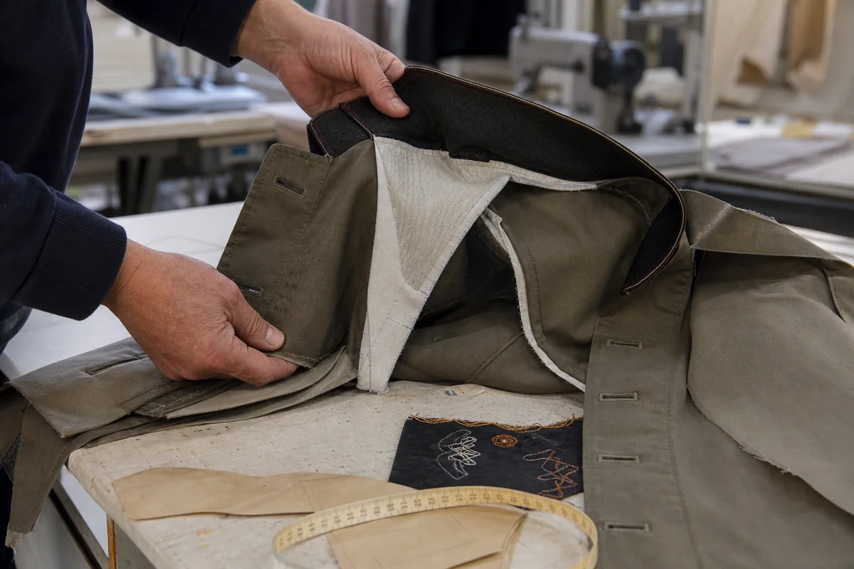 Pattern maker reviewing complex garment construction and sample details
